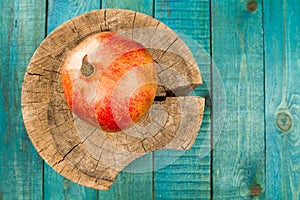 Ripe pomegranate fruit on wooden vintage background. Healthy vegetarian food.