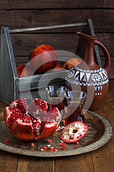 Ripe pomegranate fruit on wooden vintage background. Red juice pomegranate on dark background. Fresh juicy pomegranate -