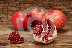 Ripe pomegranate fruits on wooden table