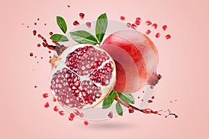 A ripe pomegranate with seeds and leaves flying in the air. Background with pomegranate fruit. Levitate. Pink. Fruit.