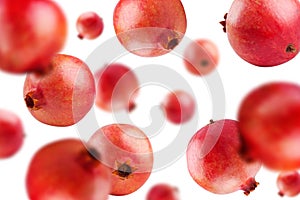 Ripe pomegranates levitate on a white background. Background with pomegranate fruit. Horizontal.