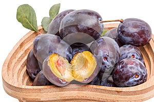 Ripe Prunes in a wooden vase