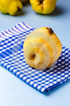 Ripe Quince fruit over blue napkin