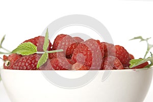 Ripe raspberry with green leaf