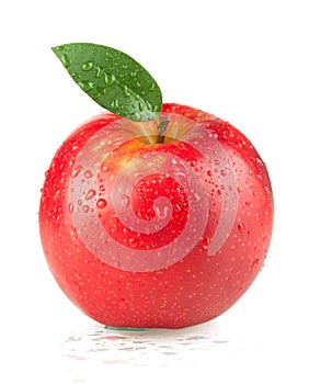 A ripe red apple with green leaf