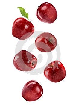 Ripe red apples falling on background