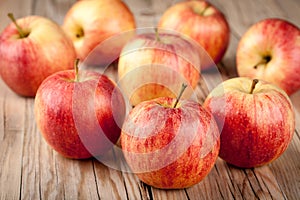 Ripe red apples on wooden table