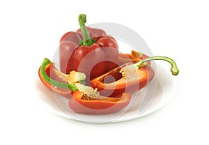 Ripe red bell peppers on a plate isolated