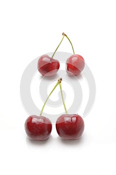 Ripe red cherry berries isolated on white background.