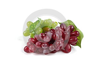 Ripe red grape. Pink bunch with leaves isolated on white. With c