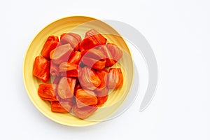 Ripe red Jackfruit in yellow plate on white