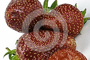 Ripe red juicy strawberries on the white background close-up