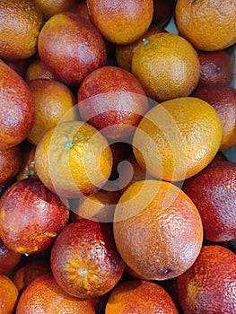 ripe red orange oranges on the counter of the marke photo