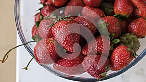 Ripe, red organic strawberries in  glass bowl. Summer fruits and berries. Selective focus