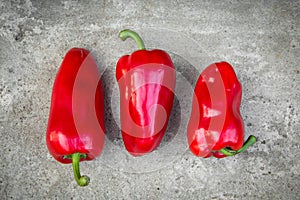 Ripe red peppers on grey background
