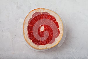 Ripe red sliced grapefruit on a light background. Healthy eating concept. Vitamins Trace elements. Flat lay