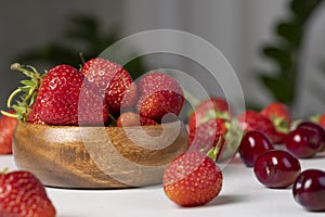 Ripe red strawberries lying on a wooden tray