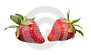 Ripe red strawberries are thrown and dropped into sparkling water, many bubbles