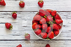 Ripe red strawberries in a white cup