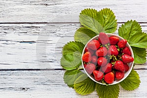 Ripe red strawberries in a white cup