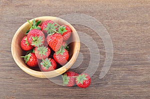 Ripe red strawberries on wooden table