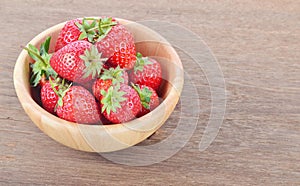 Ripe red strawberries on wooden table