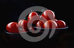 Ripe red tomatoes in a ceramic bowl