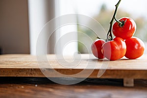 Ripe red tomatoes on a wooden board