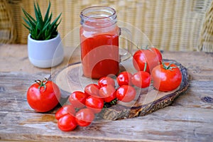 Ripe red tomatoes on wooden table, fresh tomato juice in glass, vegetarian food, Healthy Eating and Vegetarianism, Healthy