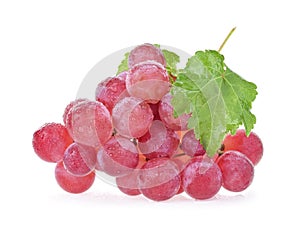 Ripe red wet grape with drops. Pink bunch with leaves isolated on white