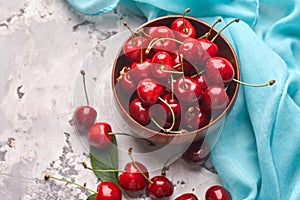 Ripe red and yellow cherries in bowl photo