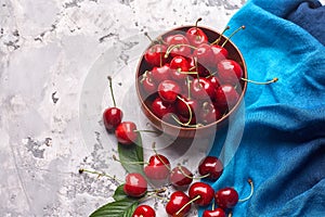Ripe red and yellow cherries in bowl photo