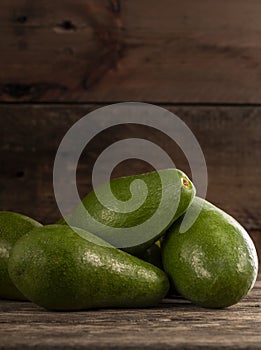 Ripe shiny avocados in heap