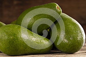 Ripe shiny avocados in heap