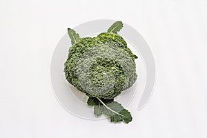 Ripe single broccoli. Fresh whole head of cabbage, green leaves.  on white background