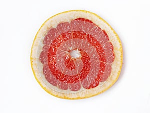 Ripe slice of pink grapefruit citrus fruit  on white background