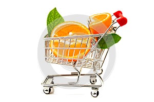 Ripe slices of orange and green leaves in metal trolley