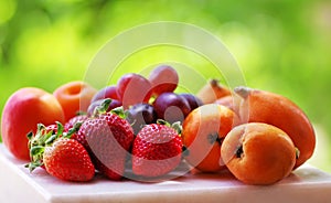 Ripe strawberries, apricot and medlars photo