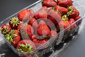 Ripe strawberries close-up. A new crop of sweet berries in a transparent tray. Healthy Food. Selective focus