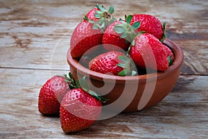 Ripe strawberries in a crookery on a table