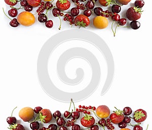 Ripe strawberries, redcurrants, apricots and cherries on white