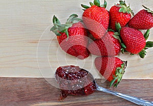 Ripe strawberries with a spoon of strawberry jam. Macro with co