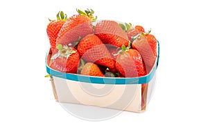 Ripe strawberry in a punnet on a white background