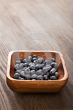 Ripe sweet blueberries on wooden table