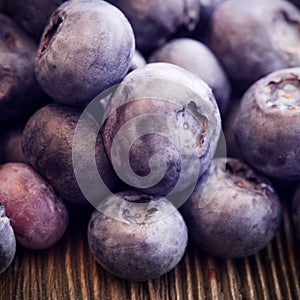 Ripe sweet blueberries on wooden table