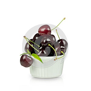 Ripe sweet cherries with leaves in white bowl. Design for product label, catalog print. Isolated on white background