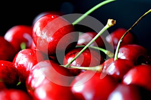 Ripe sweet cherry berries with water drops on a dark background