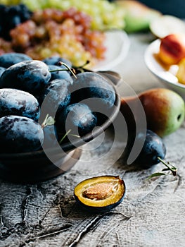 Ripe sweet plums in bowl