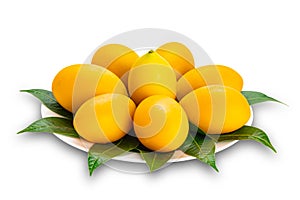 Ripe sweet yellow marian plum decorated in white ceramic dish isolated on white background