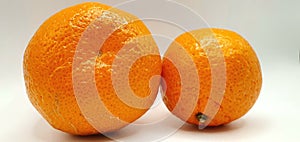 Ripe tangerine isolated close up. Citrus tangerine on a white background. Cellulite and stretch marks on the skin.